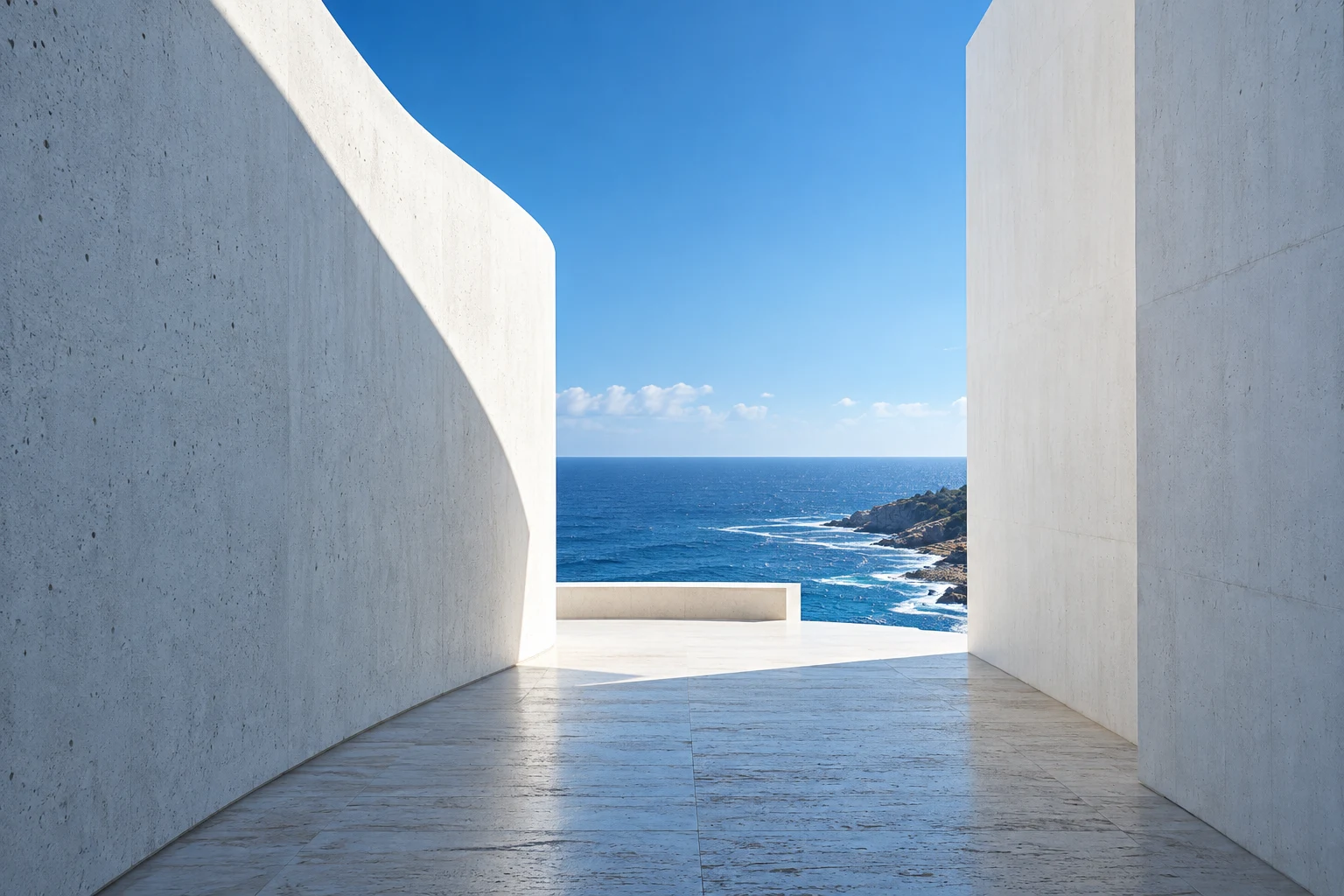 White architectural walls opening onto a blue coastal horizon